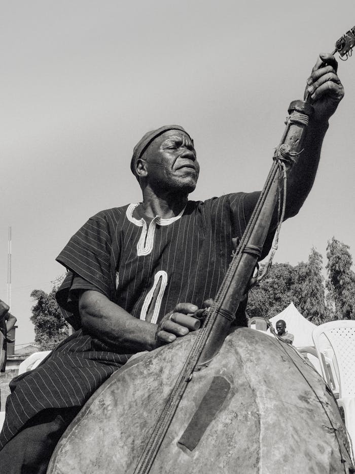 A man playing a double bass in a field